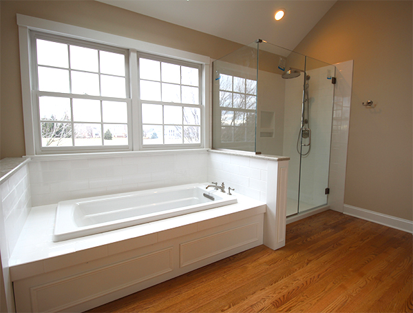 classic looking bathroom with subway tile decking around drop-in tub in bathroom in chicago, il