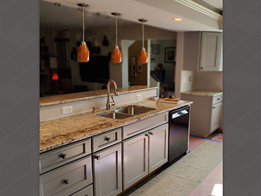 Newly remodeled kitchen with custom cabinets, lighting, flooring and counter tops in Naperville, IL